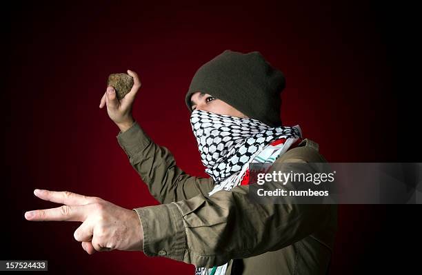 angry protestor throwing stone - flip flop stockfoto's en -beelden