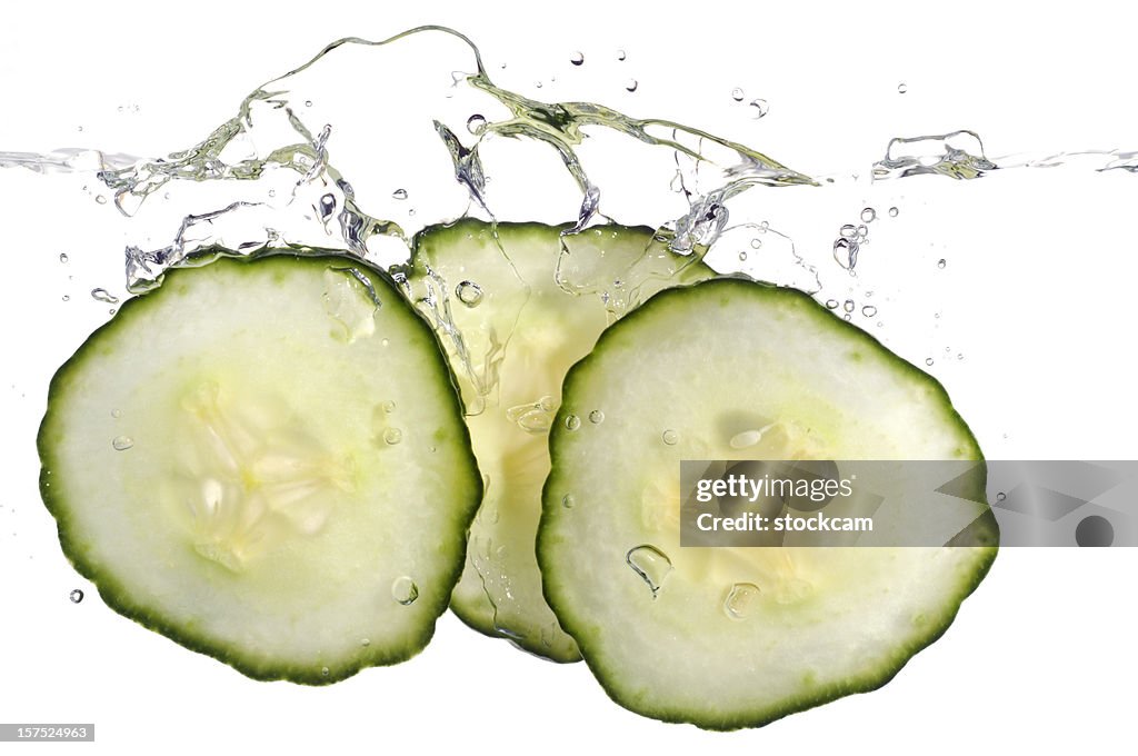 Cucumber slices splashing in water