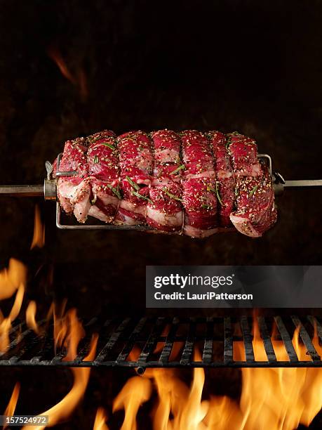 raw beef roast on the bbq - spit roasted stock pictures, royalty-free photos & images