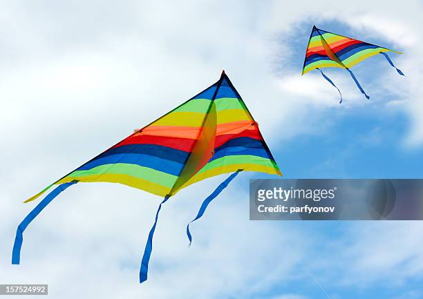 two rainbow kites flying in the sky - vlieger stockfoto's en -beelden