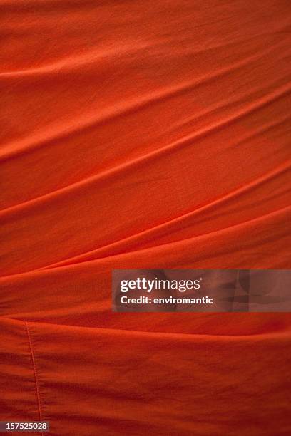 buddhist monk's saffron robe background. - saffron robes stock pictures, royalty-free photos & images