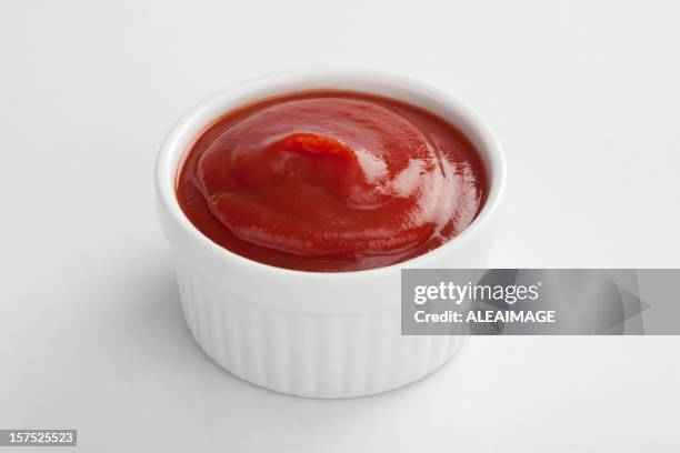 white dip cup filled with ketchup on white background - tomato sauce stock pictures, royalty-free photos & images