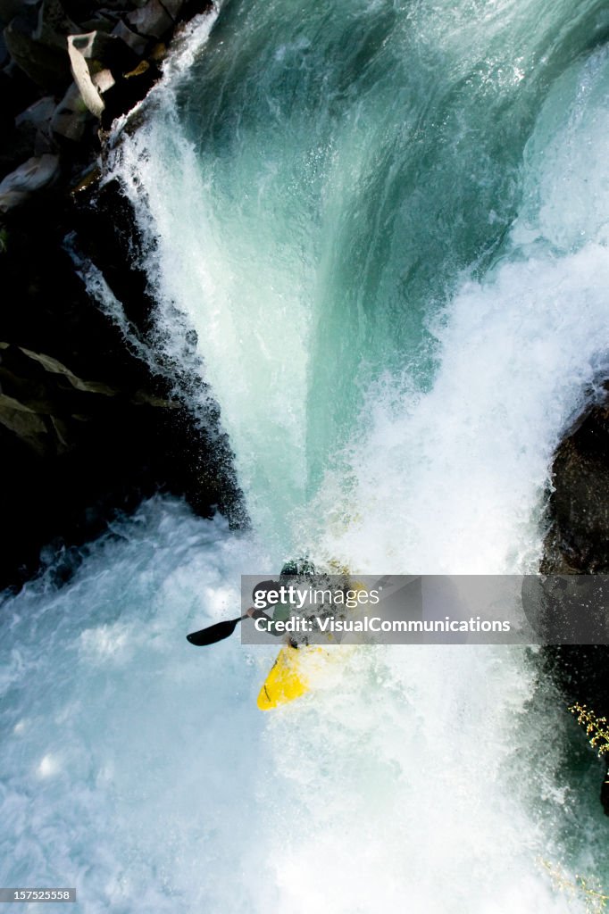 Kayaker dropping waterfall.