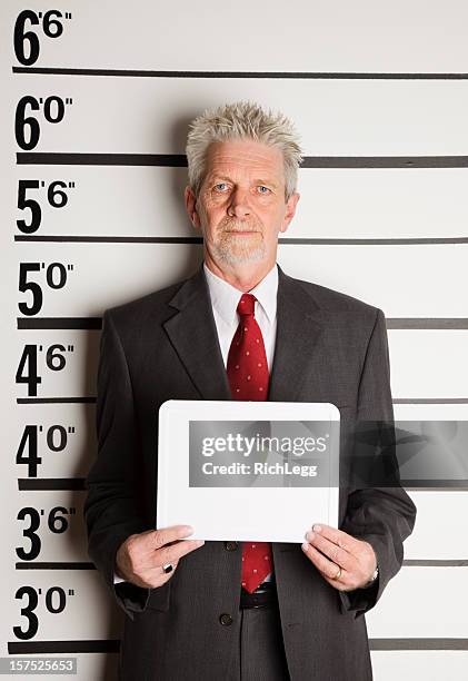 mugshot of a businessman - police line up stock pictures, royalty-free photos & images