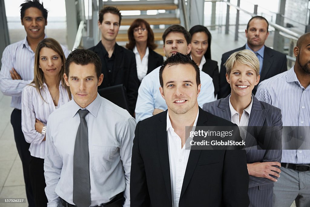 Businessman smiling with colleagues at the back