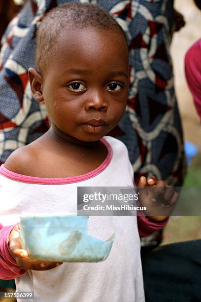 african toddler holding bowl - liberian culture stock pictures, royalty-free photos & images