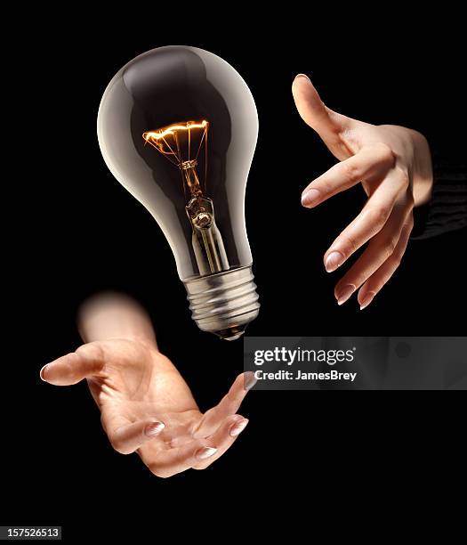 one magic idea; light bulb levitates in magician's hands - heat advisory stock pictures, royalty-free photos & images