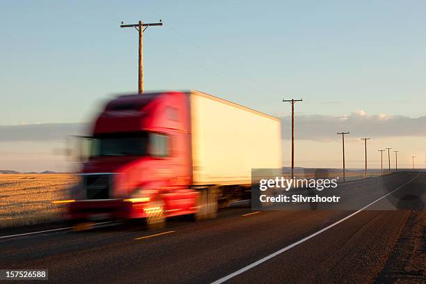 tractor trailer speeds by at sunset - trucking stock pictures, royalty-free photos & images