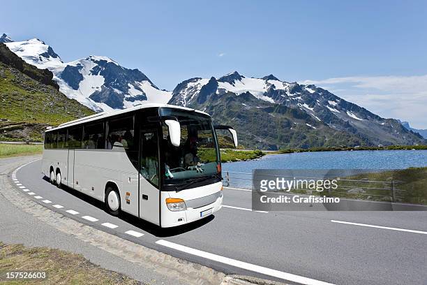 white bus crossing the alpes - coach stock pictures, royalty-free photos & images