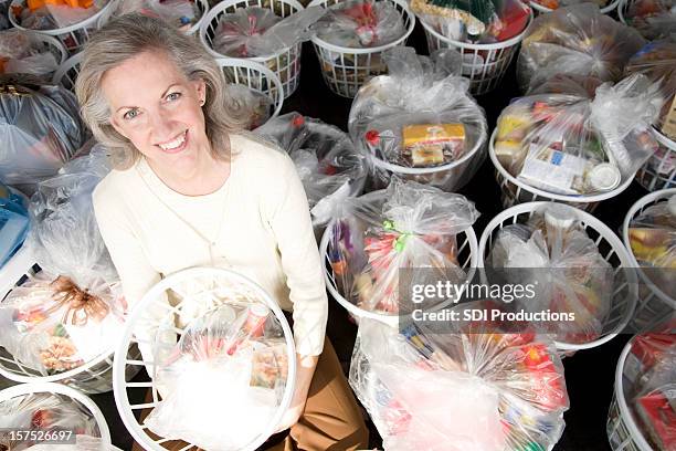senior adult woman with baskets full of groceries - meals on wheels stock pictures, royalty-free photos & images