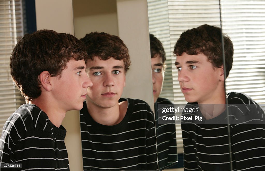 Teenage boy looks at his multiple reflections