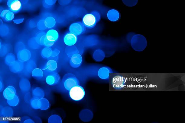 soft-focus twinkling blue lights on black - softfocus stock pictures, royalty-free photos & images