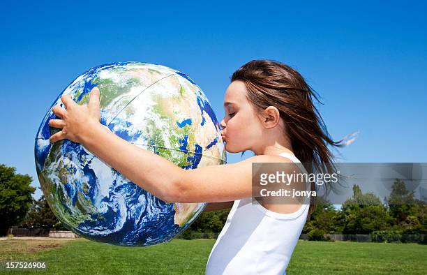 little girl hugging and kissing the globe - child globe stockfoto's en -beelden