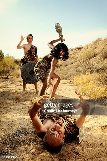 cave woman taking charge of the clan - incidental people stock pictures, royalty-free photos & images