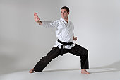 Young man in a martial arts pose with a black belt