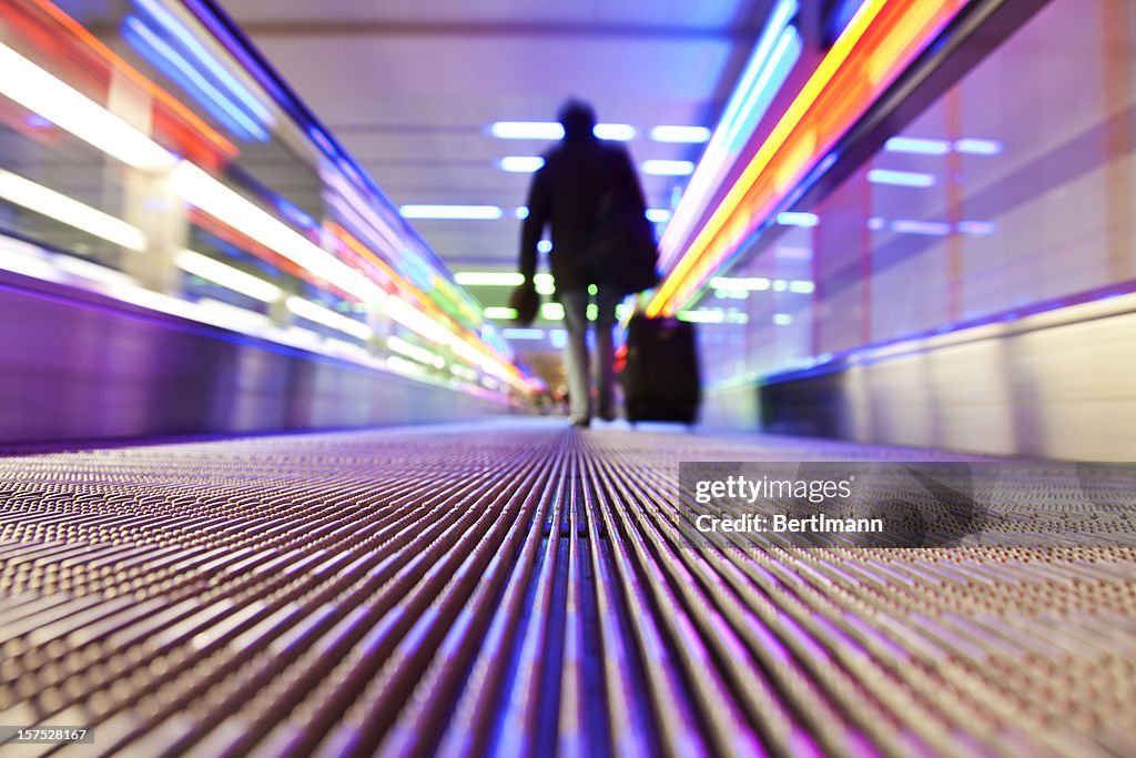 Person traveling on flat escalator