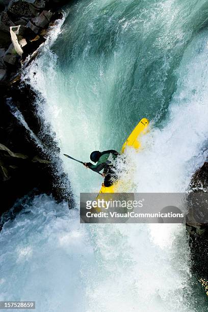 kayaker dropping the waterfall. - white water kayaking stock pictures, royalty-free photos & images