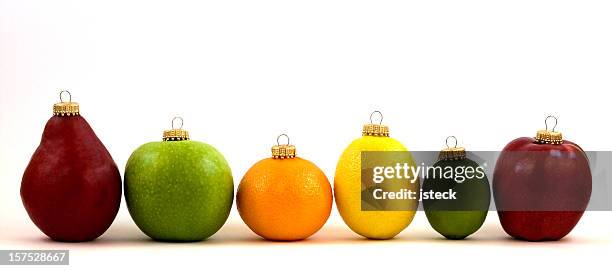 fruit christmas ornament line up - orange apple lemon stock pictures, royalty-free photos & images