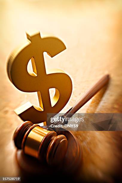 gavel lying at base of gold dollar sign - legal problems stock pictures, royalty-free photos & images