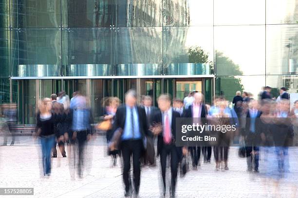 business people walking out of an office building, blurred motion - la défense paris stock pictures, royalty-free photos & images