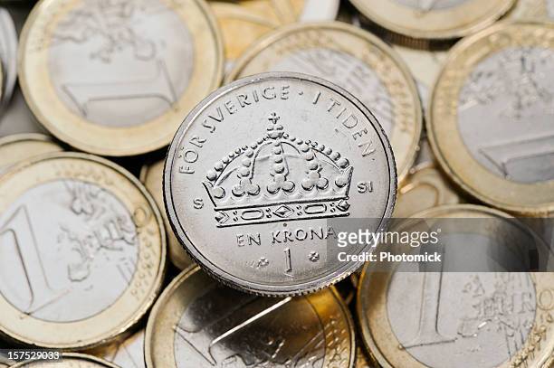 corona svedese e monete in euro - krona foto e immagini stock