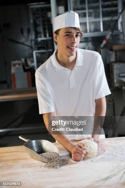 baker kneading dough - young baker stock pictures, royalty-free photos & images