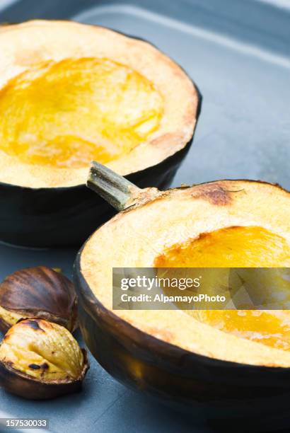 baked acorn (winter) squash and roasted chestnuts - acorn squash stock pictures, royalty-free photos & images