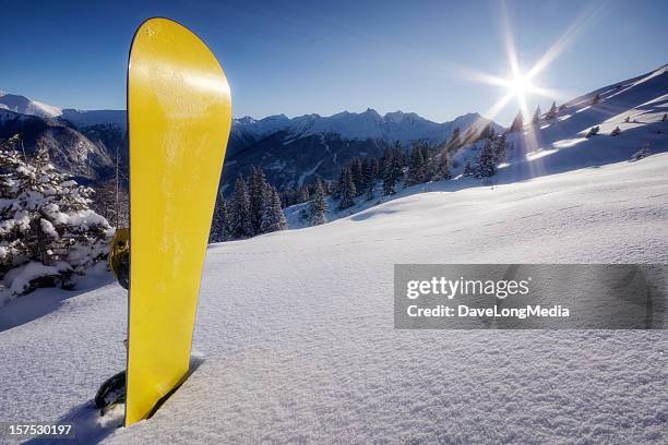 yellow snowboard in snow on mountain - bad gastein stockfoto's en -beelden