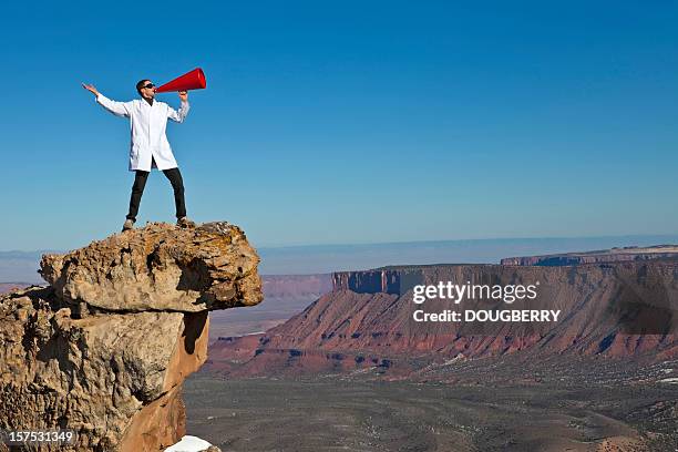 man yelling into canyon - effort work stock pictures, royalty-free photos & images
