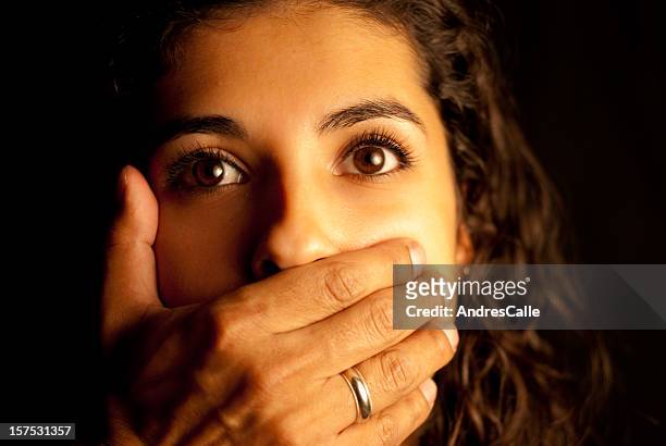 abused woman being silenced - forced marriage stockfoto's en -beelden