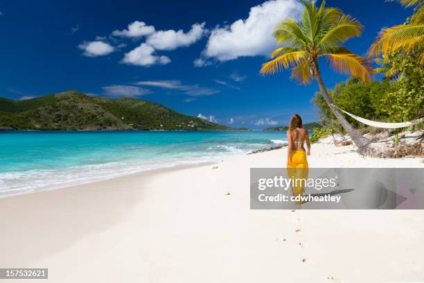 woman walking on the beach - caribbean sea stock pictures, royalty-free photos & images