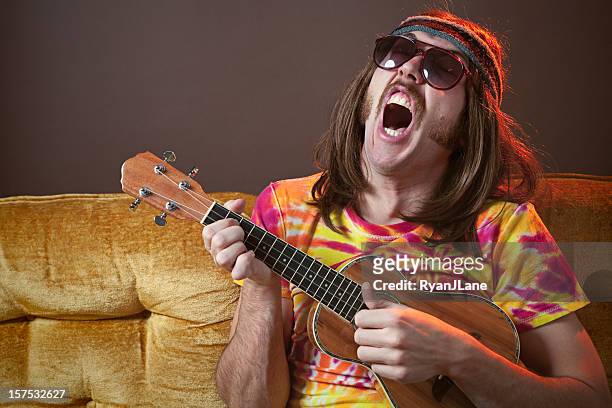 singing hippy man with ukelele - rudeness stock pictures, royalty-free photos & images