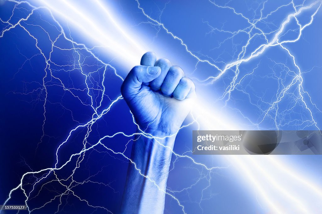 Hand holding electricity beam with rays surrounding