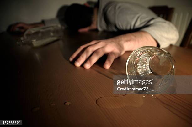 alcoholism concept man drunk laying on the table - toxin stockfoto's en -beelden