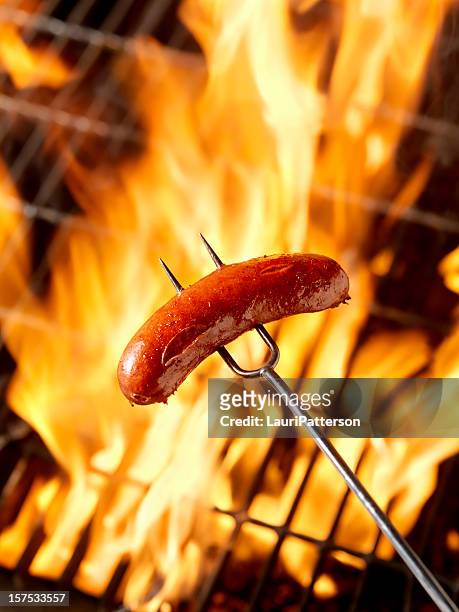 hotdog (smokie) cooking on the campfire - sausage stock pictures, royalty-free photos & images