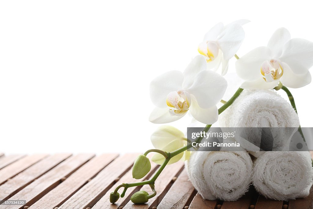 Rolled face cloths on a spa bench