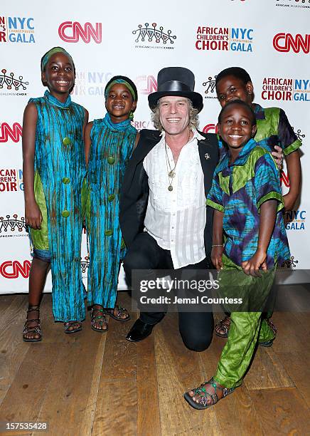 Singer Big Kenny and members of the African childrens Choir pose for a photo at the 4th Annual African Children's Choir Fundraising Gala at City...