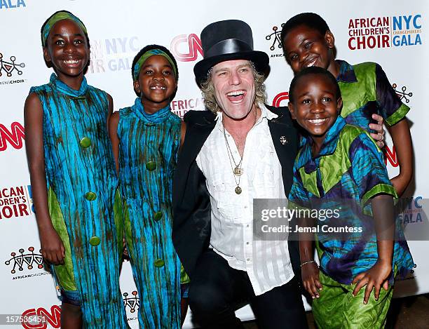 Singer Big Kenny and members of the African childrens Choir pose for a photo at the 4th Annual African Children's Choir Fundraising Gala at City...