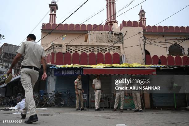 Policemen are seen stationed outside a mosque closed for Friday prayer in Gurugram, Haryana State, on August 4 following sectarian riots. Most...