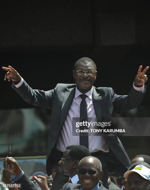 Kenyan Trade Minister Moses Wetangula gestures at supporters in Nairobi on December 4, 2012 after agreeing with Prime Minister Raila Odinga and Vice...