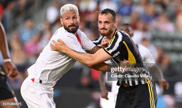 Olivier Giroud of AC Milan is challenged by Fabio Gatti of AC Milan during the Pre-Season Friendly match between Juventus and AC Milan at Dignity...