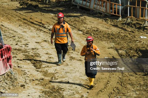 Construction workers work on site during hot weather on August 4, 2023 in Hong Kong, China. A prolonged heat weather continued to impact Hong Kong.