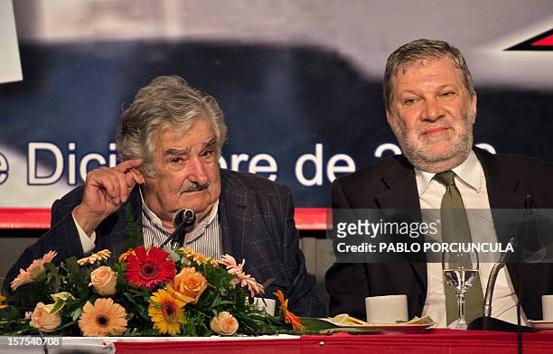 Uruguayan President Jose Mujica speaks next to his Minister of Industry, Energy and Mines, Roberto Kreimerman, during a working breakfast at the...