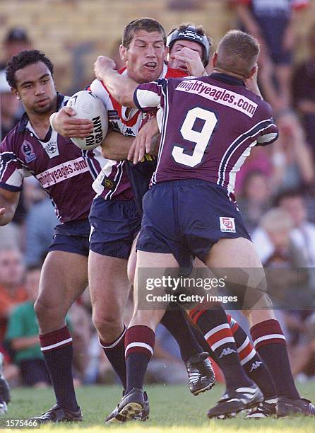 Bryan Fletcher of the Roosters wrapped up by Jamie Goddard of the Eagles during the pre-season match, Sydney Roosters v the Northern Eagles held at...