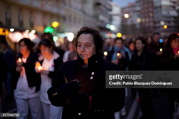 Woman carry a candle amid other health workers during a protest mourning the public health system on December 4, 2012 in Madrid, Spain. Trade unions...