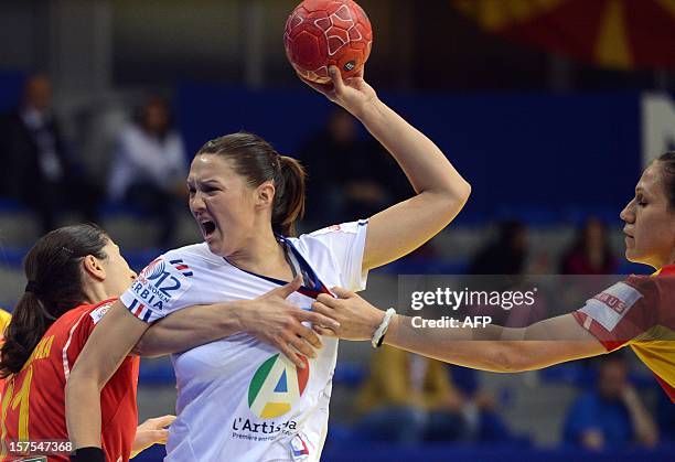 Blandine Dancette of France vies for the ball with Mirjeta Bajramovska and Natasha Mladenovska of Macedonia during their Women's EHF Euro 2012...