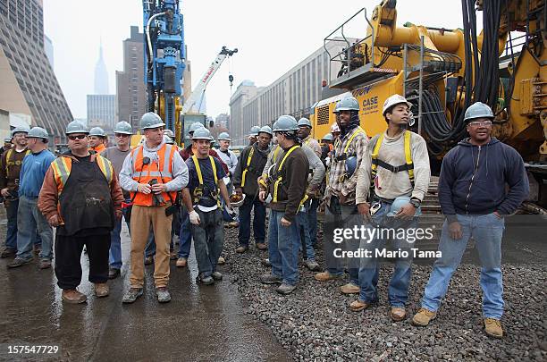 Workers gather at a groundbreaking ceremony for the Hudson Yards development at the site which is expected to boast 13 million square feet of...