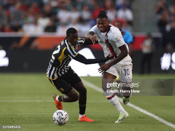 Rafael Leao of AC Milan is grabbed by Timothy Weah of Juventus for a foul during the Pre-Season Friendly match between Juventus and AC Milan at...