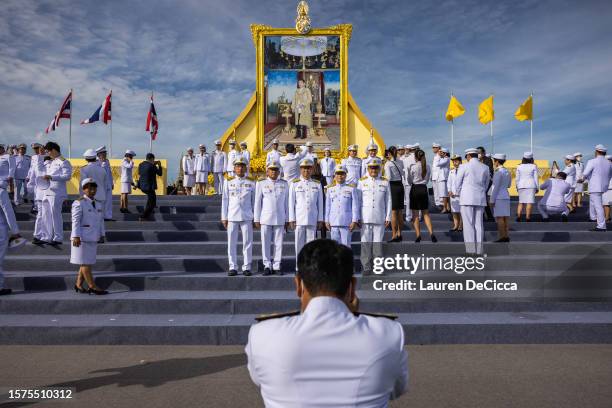 Thai government workers take photos in front of a portrait of King Maha Vajiralongkorn during his birthday celebration on July 28, 2023 in Bangkok,...