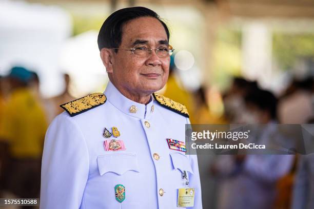 Caretaker Prime Minister, Prayut Chan-o-cha, takes part in a morning alms-giving ceremony to celebrate King Maha Vajiralongkorn's birthday on July...